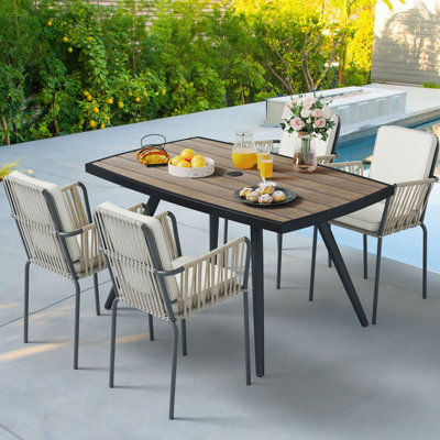 Caihla Rectangular 4 - Person Outdoor Dining Set with Cushions