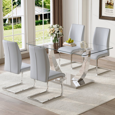 Ensemble de table et de chaises. Table de salle à manger moderne, plateau de table en verre trempé et pieds de couleur argent. Combiné avec une chaise en polyuréthane doux et confortable, parfait pour le dîner, les réunions, la maison et le bureau.