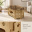 Table basse ovale de style champêtre avec plateau en verre trempé caramel et piètement en bois sculpté ajouré