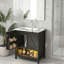 Ce meuble-lavabo moderne noir comprend un lavabo, un éclairage à DEL, deux portes d'armoire à fermeture en douceur et un rangement intégré. Il est sophistiqué, pratique et élégant.