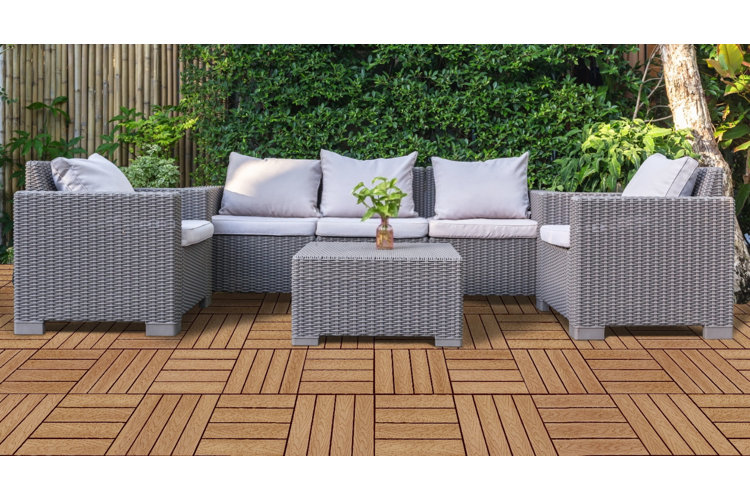 deck with brown parquet-like tile and a gray rattan outdoor patio set