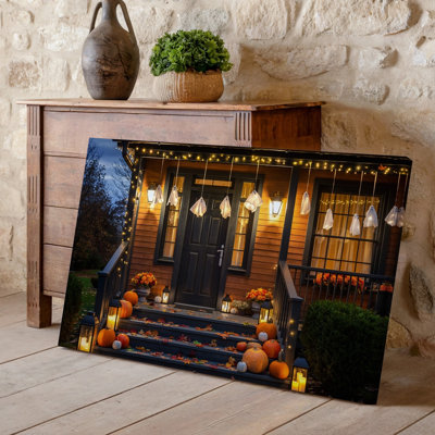 Canvas A Cozy Halloween Scene Featuring A Wooden Porch Adorned With Wall Art Glowing String Lights And Playful Ghost Decorations Canvas Wall Art