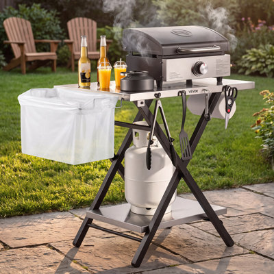 Table de cuisson pliante en acier inoxydable de 76 x 61 cm, idéale pour le camping, les pique-niques, les barbecues et les fêtes d'avant-match. Capacité de 32 kg, hauteur réglable, support à pizza extérieur à 2 niveaux, tablette de garage, porte-essuie-tout.