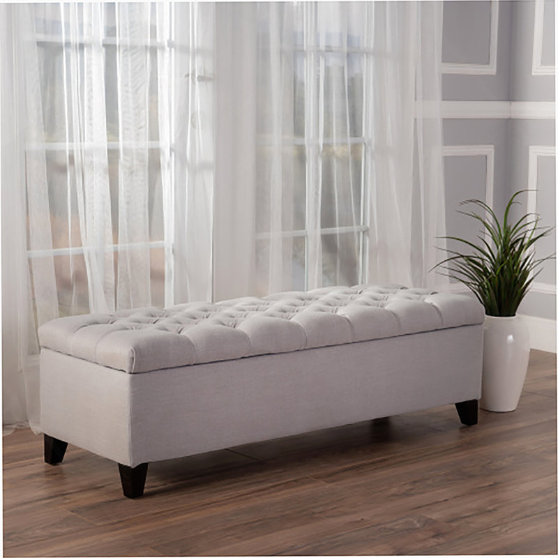 Repose-pieds de rangement contemporain avec capitonnage à boutons profonds et coutures en losange, idéal pour une utilisation polyvalente dans n'importe quel décor
