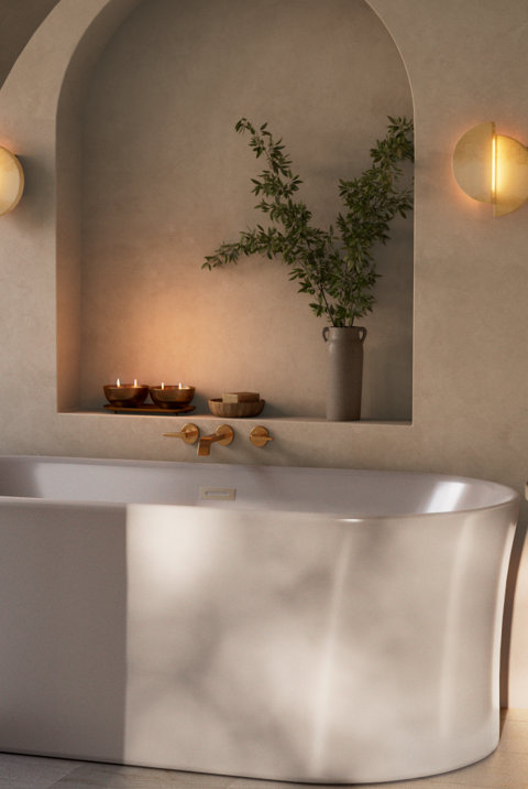 Bathtub with niche including candles and a plant