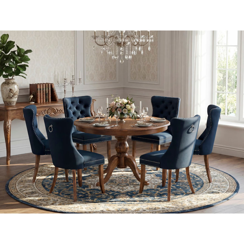 L'ensemble de salle à manger moderne de 7 pièces comprend une table ronde de 48 po au fini noyer antique, accompagnée de 6 chaises en polyester bleu marine avec un dossier élégamment capitonné.