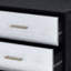 Commode noire, argentée et dorée