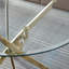 Table de salle à manger ronde contemporaine en verre trempé transparent avec pieds en acier inoxydable à finition dorée