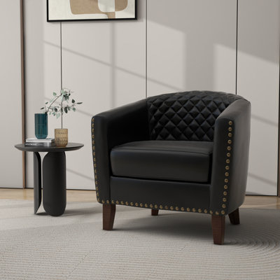 Fauteuil demi-tonneau capitonné en similicuir noir Edvardas