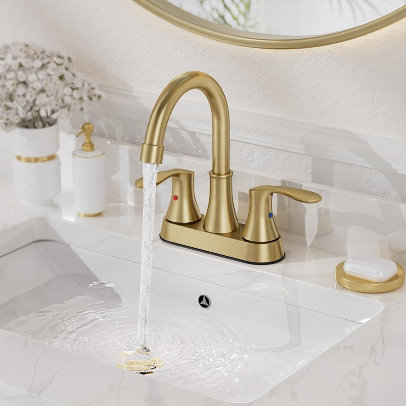 Robinet de salle de bain Mosson à deux poignées en or brossé, avec bec courbé et bonde escamotable en plastique