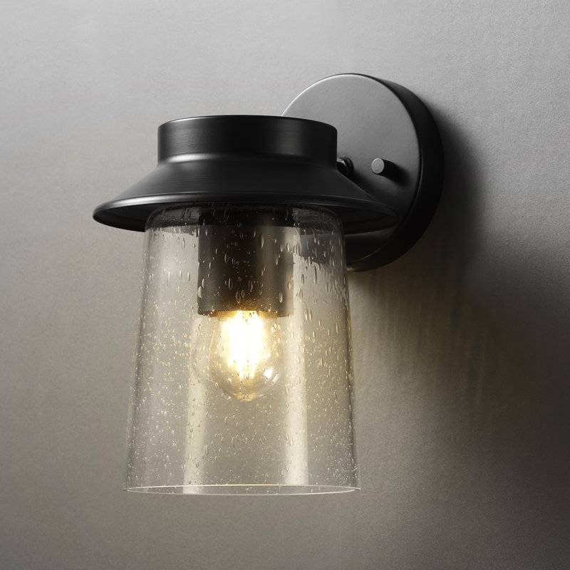 Matte Black LED Integrated Outdoor Solar Wall Sconce with Seeded Glass Shade and Faux Filament Bulb
