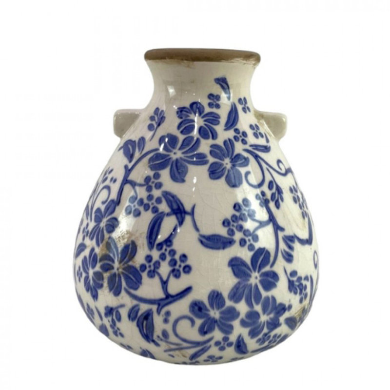 Motif floral bleu sur vase blanc rustique