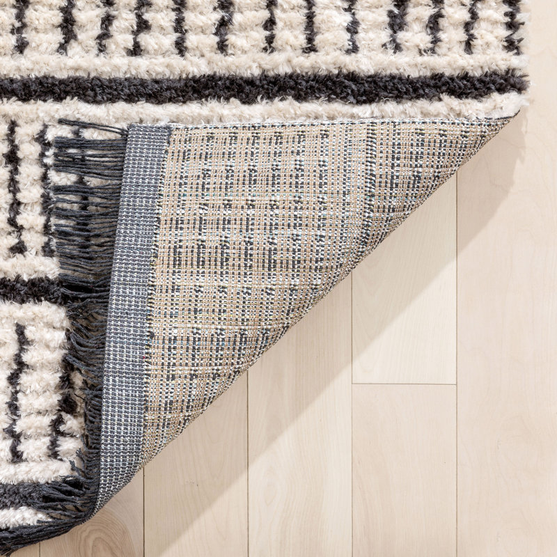 Ivory and Black Geometric Synthetic 4' x 6' Area Rug