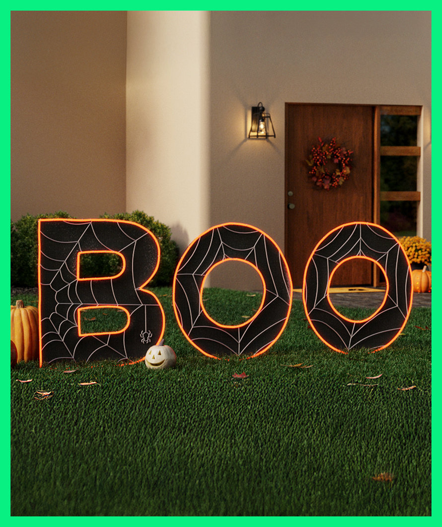 BOO lawn decorations with spiderwebs