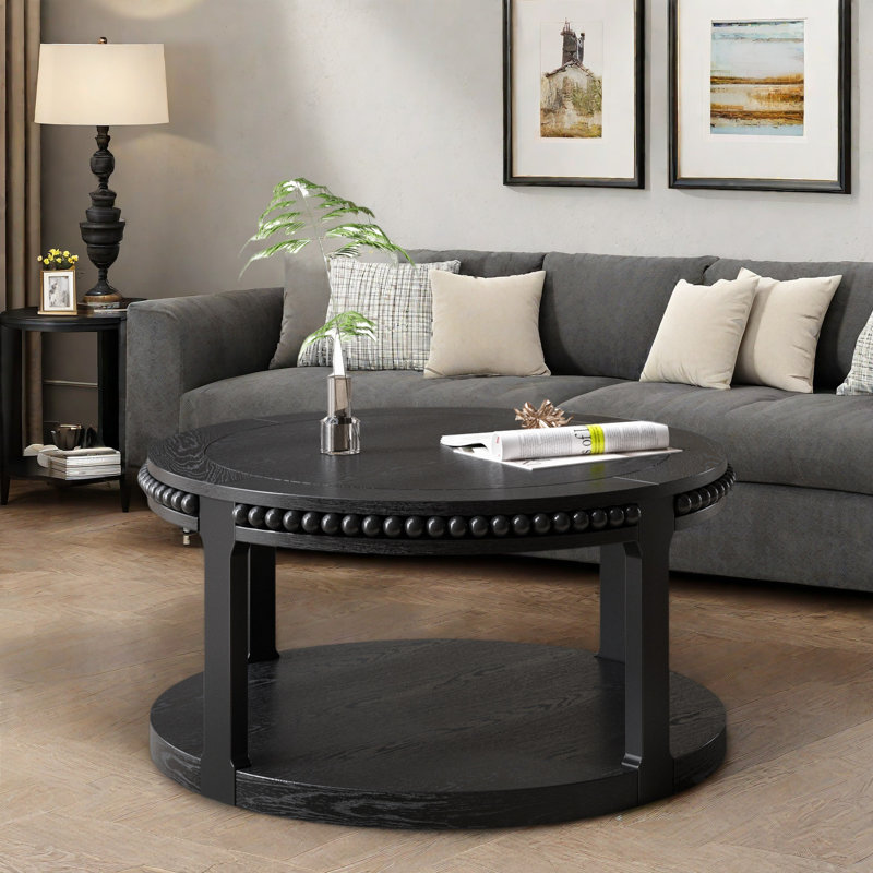 Table basse ronde avec plateau épaissi à deux niveaux, pieds robustes et motif perlé, Noir