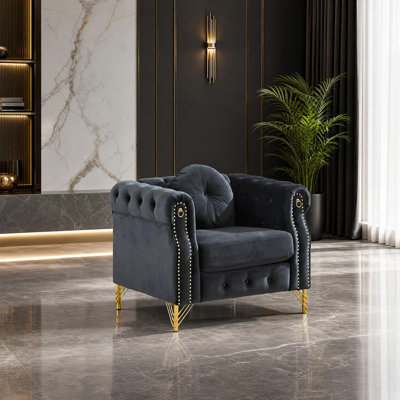 Canapé Chesterfield en velours avec anneaux décoratifs sur les accoudoirs