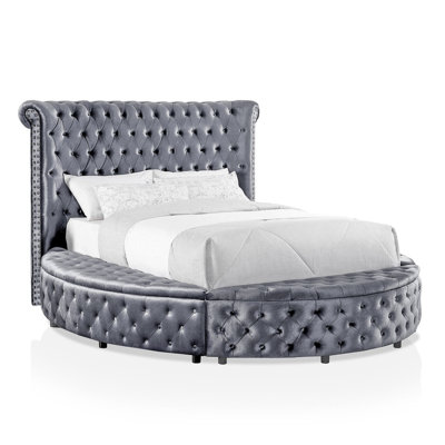 Round King Bed Featuring Gray Upholstery, Button - Detailing, And Storage In Rail With Design, Compartments, Ports On Headboard
