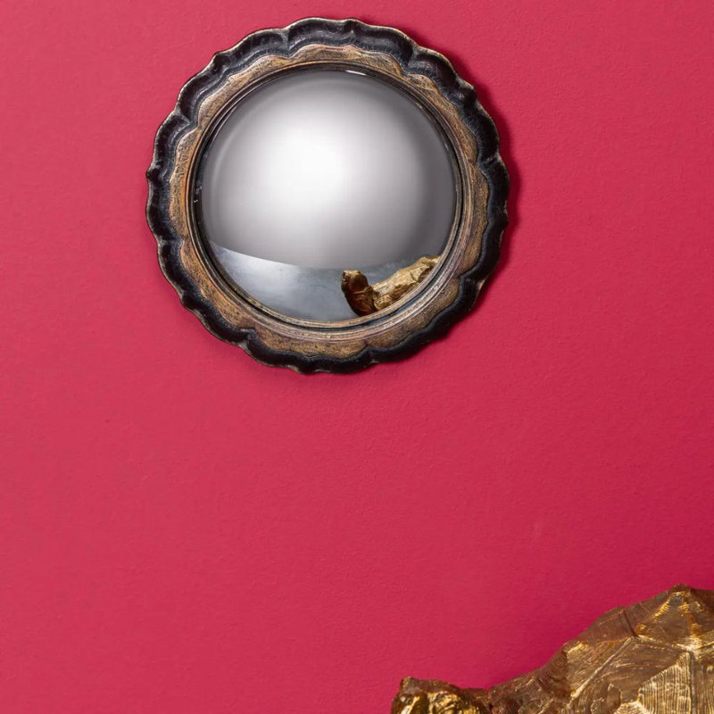 Miroir convexe noir et fleur dorée