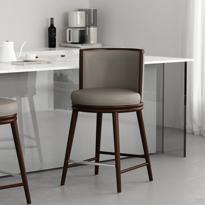 Tabouret de comptoir en similicuir Evalyn avec pieds en bois de hêtre