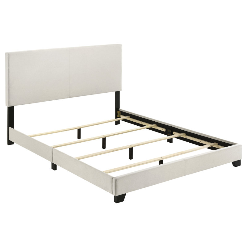 Grand lit à panneau tapissier crème avec tête de lit rembourrée, bois d'hévéa et bois d'ingénierie, pieds en bois massif noir, mousse confortable pour installation dans une chambre à coucher moderne, pieds pour