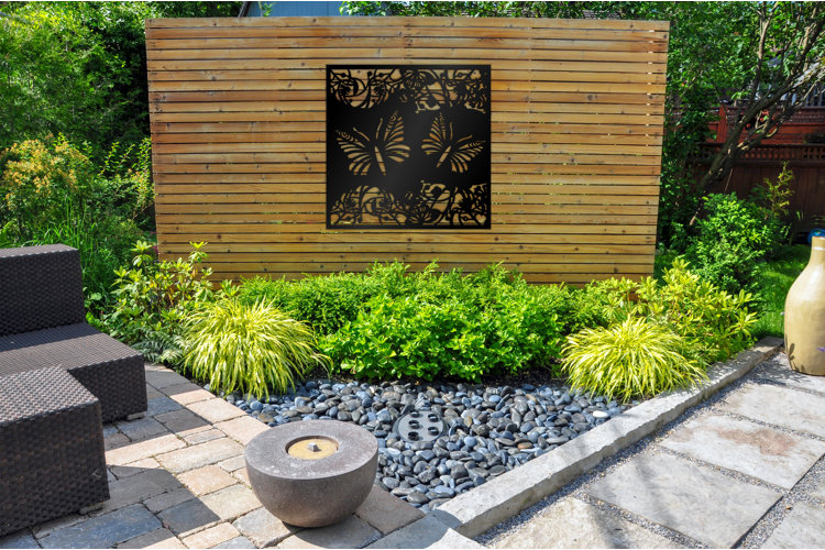 outdoor space with a concrete floor and a large wood slat privacy fence featuring a metal detail