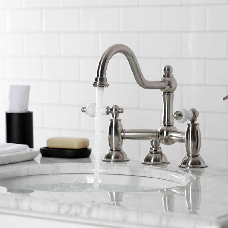 Kingston Brass Restoration Two-Handle 3-Hole Deck Mount Bridge Bathroom Faucet with Brass Pop-Up, Satin Nickel