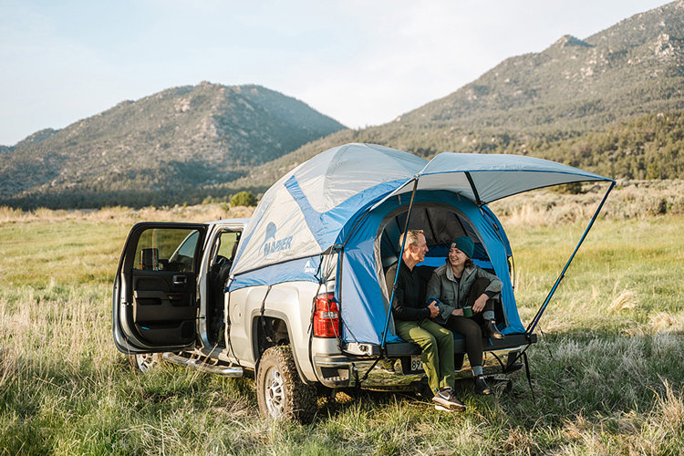 two people on a roadtrip standing outside car