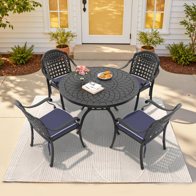 Canup 4 - Person Patio Dining Set with Round Table , Blue Cushions Included