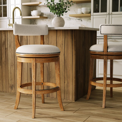 Tabouret de comptoir pivotant rembourré avec structure en bois massif Carollynn