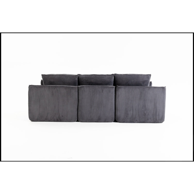 Canapé d'angle modulaire compressé en forme de L avec repose-pieds amovible et coussins nuage détachables, idéal pour les espaces de vie modernes.