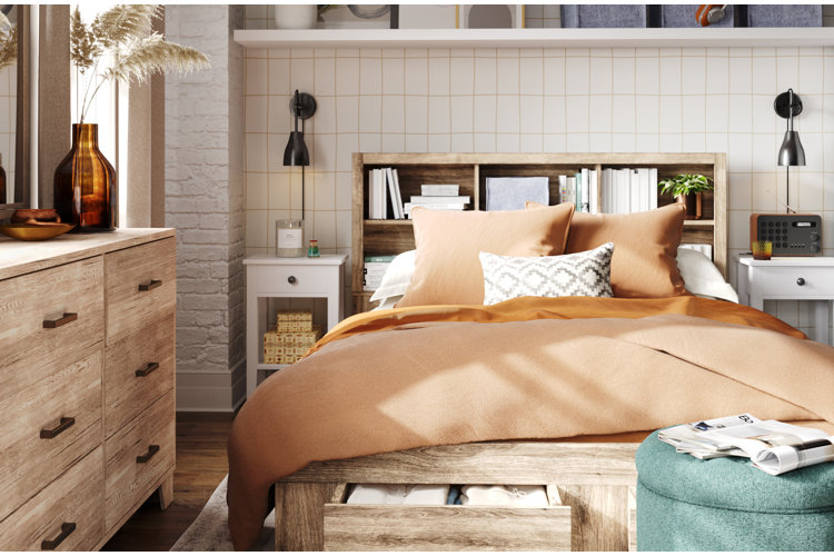 bed with a bookcase full of books as the headboard