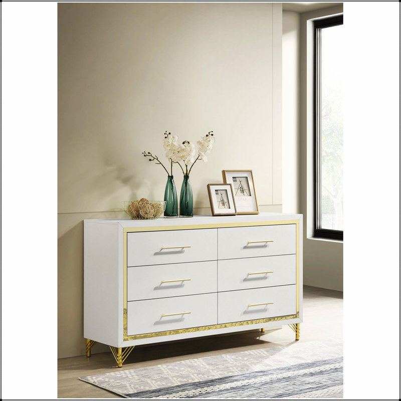La commode de chambre blanche à 6 tiroirs Chesney avec bordure dorée allie un design élégant et un grand espace de rangement pour les chambres raffinées.