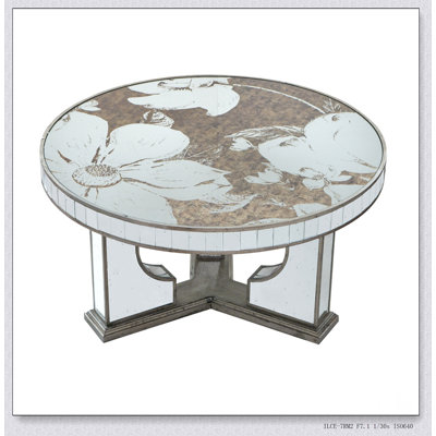 Table basse ronde de 35,5 x 35,5 x 19 pouces avec un élégant motif floral et une finition argentée en miroir, parfaite pour un décor moderne et classique.