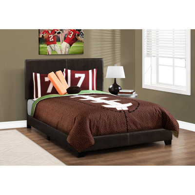 Lit double tapissier en similicuir brun avec coins