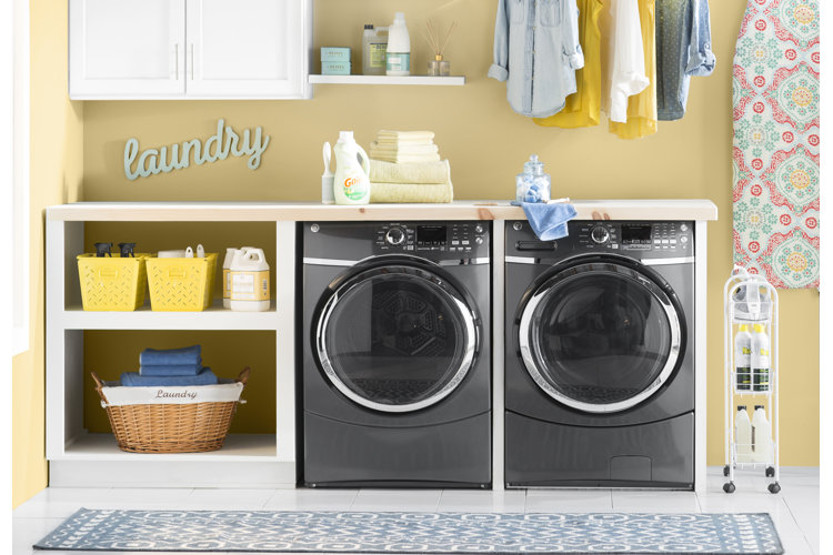 basic laundry room with a broad countertop over the washer and dryer