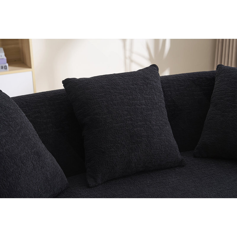 Canapé incurvé moderne sans dossier avec dossier amélioré et revêtement en chenille pour une assise confortable dans des espaces compacts.
