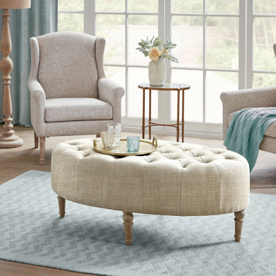 Bedford Clara 48'' W Upholstered Button Tufted Oval Accent Ottoman in Beige