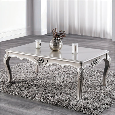 Table basse de style traditionnel avec pieds courbés et structure sculptée en bois massif