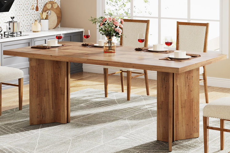 rectangular wooden kitchen table set with upholstered chairs and floral centerpiece