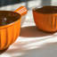 Set of Matt orange reactive glaze handled bowls small and large