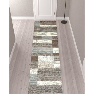 12' Light Blue And Ivory Patchwork Resistant Runner Rug