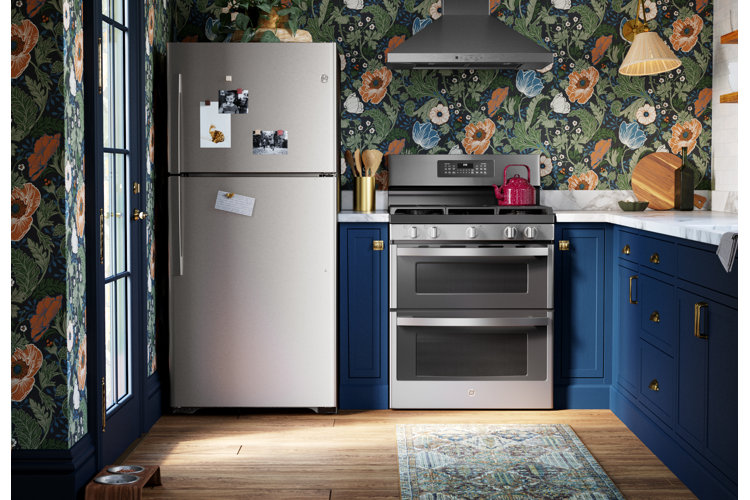 budget kitchen remodel with new silver refrigerator floral wallpaper and royal blue cabinets