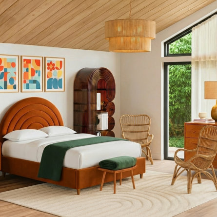 A 70s style bedroom featuring an orange arched headboard, colorful abstract wall art, a wood ceiling, rattan chairs, and a tiered pendant light