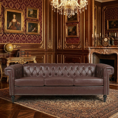 Fauteuil club Chesterfield en similicuir capitonné avec garniture cloutée