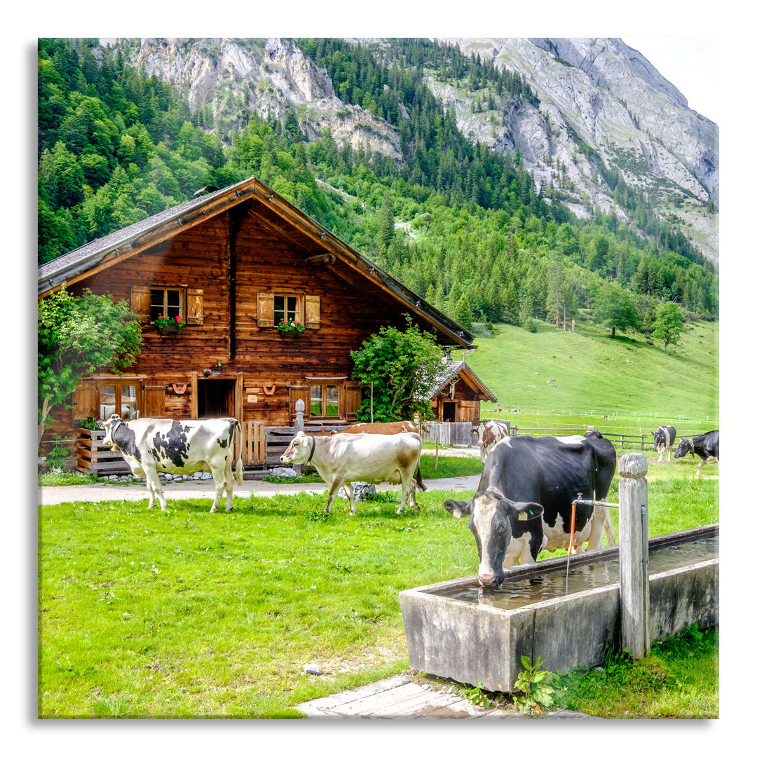 Glasbild Kühe vor Blockhütte auf Alpenweide