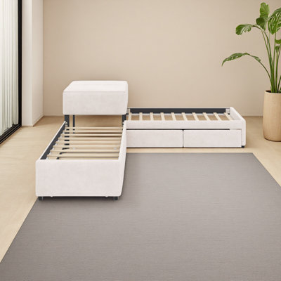 Lit plateforme tapissier en L avec lit gigogne et deux tiroirs reliés par un bureau intégré, lit simple