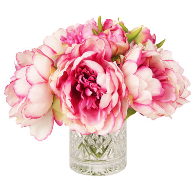 Pivoines disposées dans un vase en verre