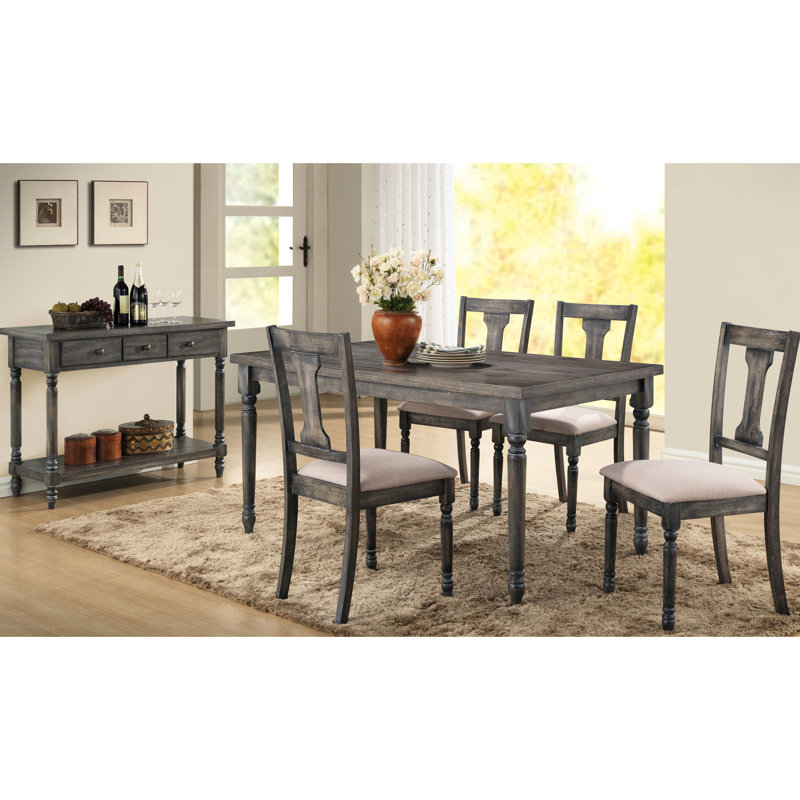 Table rectangulaire grise avec pieds tournés robustes et élégants, idéale pour les repas, 6 couverts, style rustique et fiable.