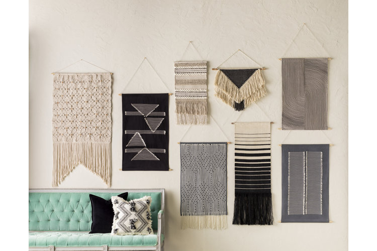 Gallery wall featuring a variety of macrame wall hangings.