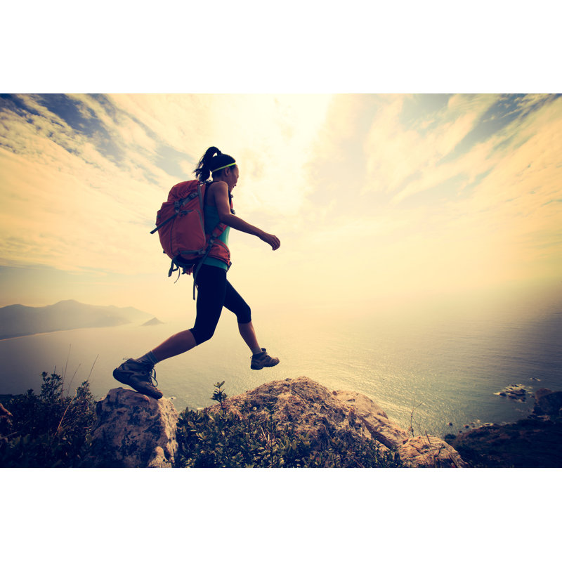 Hiker Jumping On Mountain by Lzf - Wrapped Canvas Print, 81cm H x 122cm W